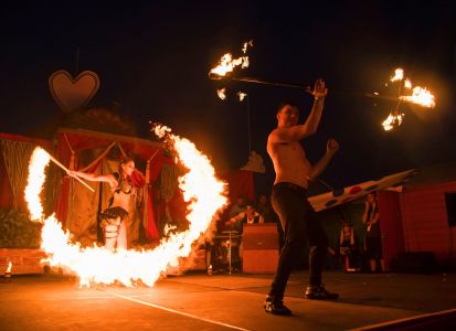 stage performers with fire
